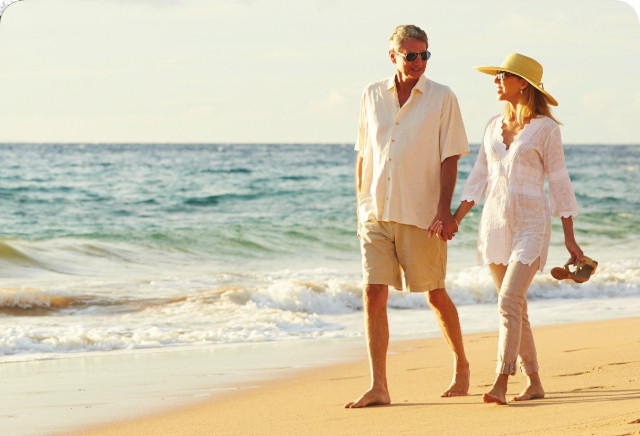 Couple walking on a beach by the sea